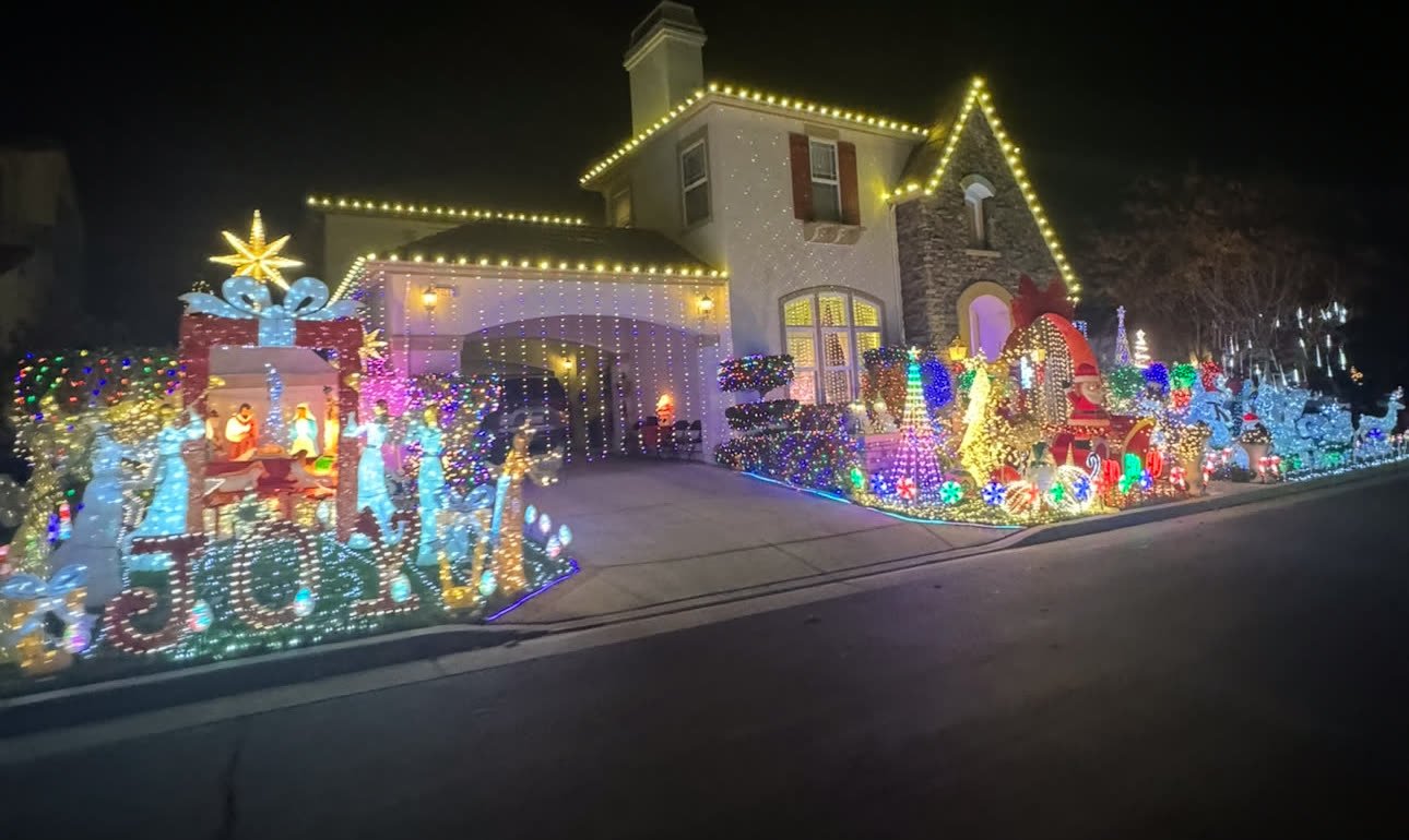 A full holiday display with lit JOY letters and figures